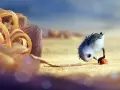 Un pulcino spaventato cerca cibo sulla spiaggia, un'immagine che cattura il significato del cortometraggio "Piper" sulla crescita e il coraggio.