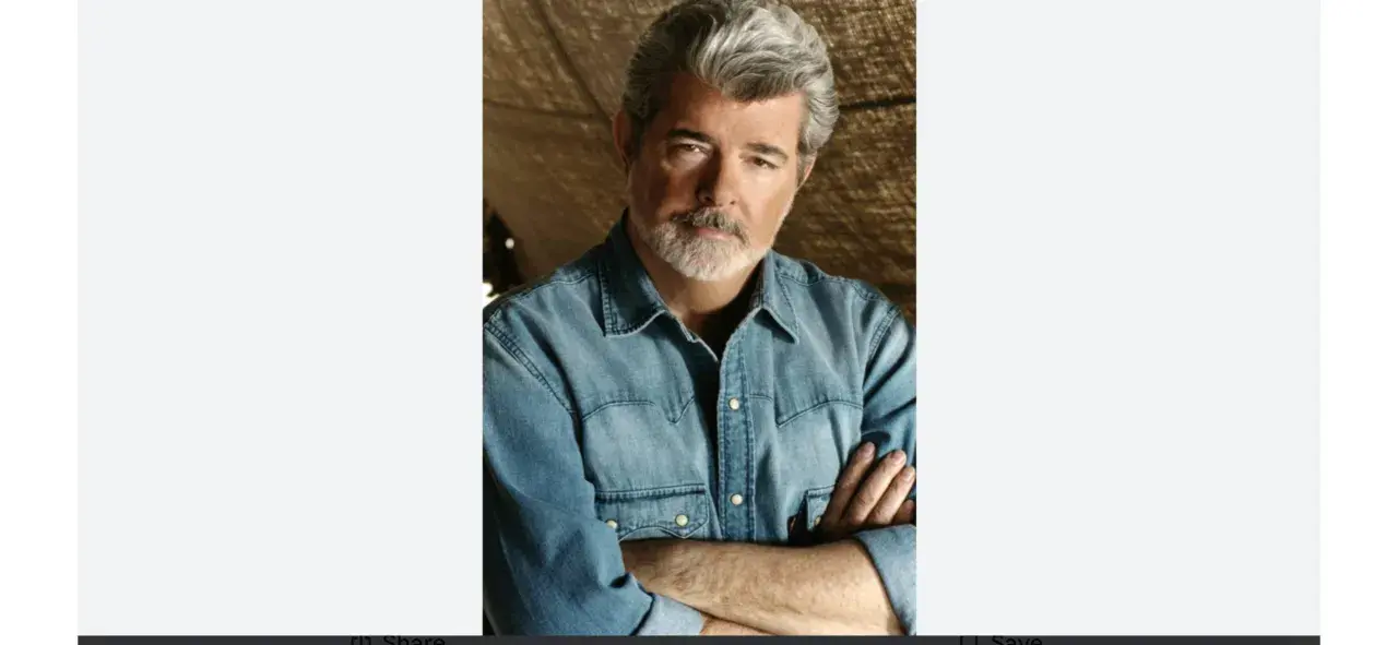 George Lucas, uno dei registi importanti, con barba grigia e camicia di jeans, braccia conserte.