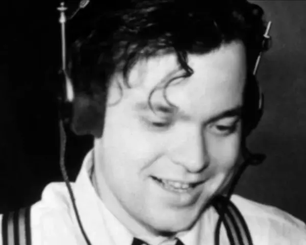 Orson Welles, giovane e sorridente con cuffie, un'immagine che evoca la sua genialità, ma non il suo orson welles causa morte.