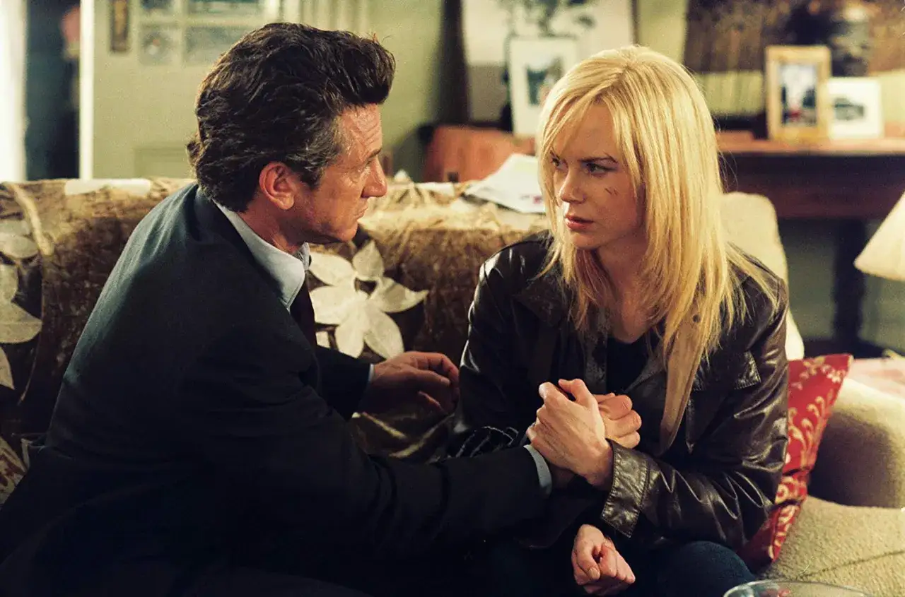 Sean Penn e Nicole Kidman si tengono per mano, un momento intenso che riflette la trama di 